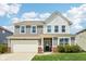 Charming two-story home with a front yard, attached garage, and inviting curb appeal at 10358 Pronghorn Ln, Indianapolis, IN 46239