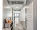 Inviting entryway with gray walls, luxury vinyl plank flooring, and a decorative welcome sign at 10358 Pronghorn Ln, Indianapolis, IN 46239