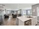 Open-concept kitchen offers quartz countertops, an island bar, and a view into the living area at 10358 Pronghorn Ln, Indianapolis, IN 46239