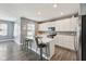 Bright kitchen features white cabinets, an island with a breakfast bar, and stainless steel appliances at 10358 Pronghorn Ln, Indianapolis, IN 46239