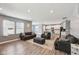 Open-concept living room showcasing luxury vinyl plank flooring and seamless flow into the kitchen at 10358 Pronghorn Ln, Indianapolis, IN 46239
