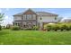 Expansive backyard featuring green lawn and patio with outdoor seating at 10473 Ranford Blvd, Fishers, IN 46040