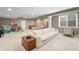 Open basement layout with playroom, bedroom, living room with neutral sofa, and lots of natural light at 10473 Ranford Blvd, Fishers, IN 46040