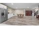 Open basement layout with kitchenette, stainless steel refrigerator and dark wood entertainment center at 10473 Ranford Blvd, Fishers, IN 46040