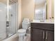 Bathroom featuring a standing shower, wood vanity, and bright lighting at 10473 Ranford Blvd, Fishers, IN 46040