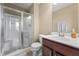 Well-lit bathroom featuring a glass shower, modern vanity with storage, and neutral wall color at 10473 Ranford Blvd, Fishers, IN 46040