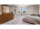 Well-lit bedroom with dresser, and two bright windows with blinds at 10473 Ranford Blvd, Fishers, IN 46040