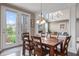 Dining area featuring an outside view and chandelier with an open concept to the living room at 10473 Ranford Blvd, Fishers, IN 46040
