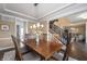 Formal dining room features a wood table, seating for six, hardwood floors, and natural lighting at 10473 Ranford Blvd, Fishers, IN 46040