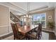 Traditional dining room with hardwood floors, large window, and wood table with seating for six at 10473 Ranford Blvd, Fishers, IN 46040