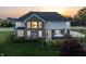 Two-story home with brick and siding exterior, complemented by a well-manicured lawn at sunset at 10473 Ranford Blvd, Fishers, IN 46040