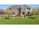 Beautiful two-story brick home with a manicured lawn and lovely landscaping at 10473 Ranford Blvd, Fishers, IN 46040