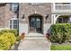 Inviting front entrance with a brick archway, stone accents, and decorative landscaping at 10473 Ranford Blvd, Fishers, IN 46040