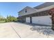 Attached three-car garage with a long driveway and exterior brick and siding at 10473 Ranford Blvd, Fishers, IN 46040