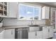 The kitchen is equipped with stainless steel appliances, white cabinets, and quartz countertops at 10473 Ranford Blvd, Fishers, IN 46040