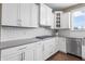The kitchen is equipped with stainless steel appliances, white cabinets, and modern countertops at 10473 Ranford Blvd, Fishers, IN 46040