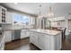 Bright kitchen boasts a central island, white cabinetry, stainless steel appliances, and an open layout at 10473 Ranford Blvd, Fishers, IN 46040