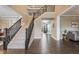 Spacious staircase with carpeted steps and a dark wood banister in a light-filled home at 10473 Ranford Blvd, Fishers, IN 46040