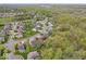 An aerial view shows a neighborhood nestled among lush trees at 10531 Cleary Trce, Fishers, IN 46040