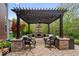 Charming outdoor patio with a stone fireplace, pergola, and comfortable seating area at 10531 Cleary Trce, Fishers, IN 46040