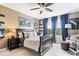 Well-lit bedroom with dark wood furniture, blue curtains, and a comfortable chair at 10531 Cleary Trce, Fishers, IN 46040