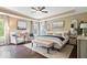 Well-lit bedroom featuring neutral tones, modern decor, and a view of the landscaped yard at 10531 Cleary Trce, Fishers, IN 46040