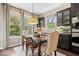 Cozy dining area adjacent to kitchen, with a wooden table, neutral chairs, and plenty of natural light at 10531 Cleary Trce, Fishers, IN 46040
