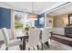 An inviting dining room is set with stylish chairs, a wooden table, and contemporary chandelier lighting at 10531 Cleary Trce, Fishers, IN 46040