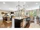 Open-concept kitchen features a central island with seating, and flows into the living/dining areas for an inviting space at 10531 Cleary Trce, Fishers, IN 46040