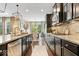 Modern kitchen showcases dark cabinetry, granite counters, and an open layout for cooking and entertaining at 10531 Cleary Trce, Fishers, IN 46040