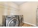 Convenient laundry room features modern washer and dryer units with ample shelving for organization at 10531 Cleary Trce, Fishers, IN 46040