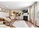 Cozy living room with a fireplace, comfortable seating, and natural light at 10531 Cleary Trce, Fishers, IN 46040