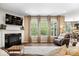 Bright living room with a fireplace, large windows, and stylish decor at 10531 Cleary Trce, Fishers, IN 46040