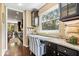 Charming office nook featuring granite counters, dark wood cabinets, natural light, and a comfortable chair at 10531 Cleary Trce, Fishers, IN 46040