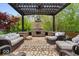 Inviting outdoor patio with stone fireplace, comfortable seating, perfect for entertaining or relaxing at 10531 Cleary Trce, Fishers, IN 46040