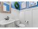 Charming powder room with blue accent wall, white wainscoting, and decorative fixtures at 10531 Cleary Trce, Fishers, IN 46040