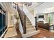 Elegant staircase with wood and wrought iron railing, leading to the upper level at 10531 Cleary Trce, Fishers, IN 46040