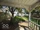 Covered patio overlooking backyard featuring a lawn and home at 113 1St St, Shelbyville, IN 46176
