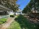 Backyard view featuring a sidewalk leading to a small deck at 113 1St St, Shelbyville, IN 46176