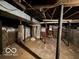 Unfinished basement with mechanical components and concrete flooring at 113 1St St, Shelbyville, IN 46176