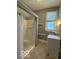 Bathroom with shower/tub combo, gray walls, and vanity with a window at 113 1St St, Shelbyville, IN 46176