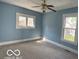 Bright bedroom with carpet, fan, natural light from windows and light blue walls at 113 1St St, Shelbyville, IN 46176