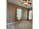 Neutral bedroom featuring a fan, carpet, and natural light from two windows at 113 1St St, Shelbyville, IN 46176