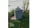 Home's A/C unit on a concrete slab surrounded by foliage at 113 1St St, Shelbyville, IN 46176