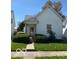 Quaint two-story house featuring a well-manicured front lawn and covered entryway at 113 1St St, Shelbyville, IN 46176