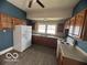 Spacious kitchen with wood cabinets, laminate countertops and new light grey vinyl flooring at 113 1St St, Shelbyville, IN 46176