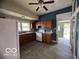 Traditional kitchen with wood cabinets, laminate countertops and new light grey vinyl flooring at 113 1St St, Shelbyville, IN 46176