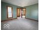 Open living room with gray carpeting, neutral paint and natural light at 113 1St St, Shelbyville, IN 46176