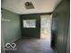 Green colored mud room off of the kitchen featuring vinyl flooring and an exterior exit at 113 1St St, Shelbyville, IN 46176
