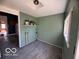 Green colored mud room off of the kitchen featuring vinyl flooring and an exterior exit at 113 1St St, Shelbyville, IN 46176